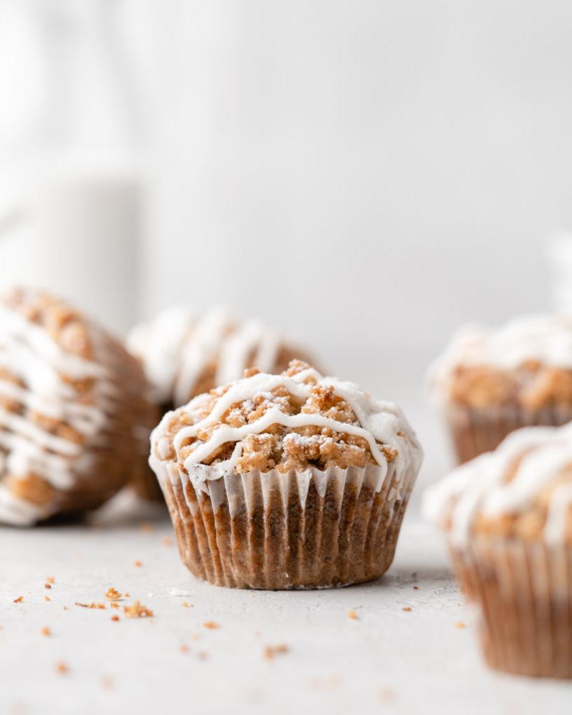 These moist banana muffins are topped with a buttery streusel topping and a simple creamy glaze!