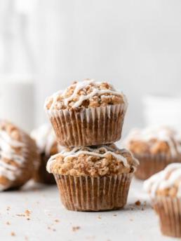 These moist banana muffins are topped with a buttery streusel topping and a simple creamy glaze!