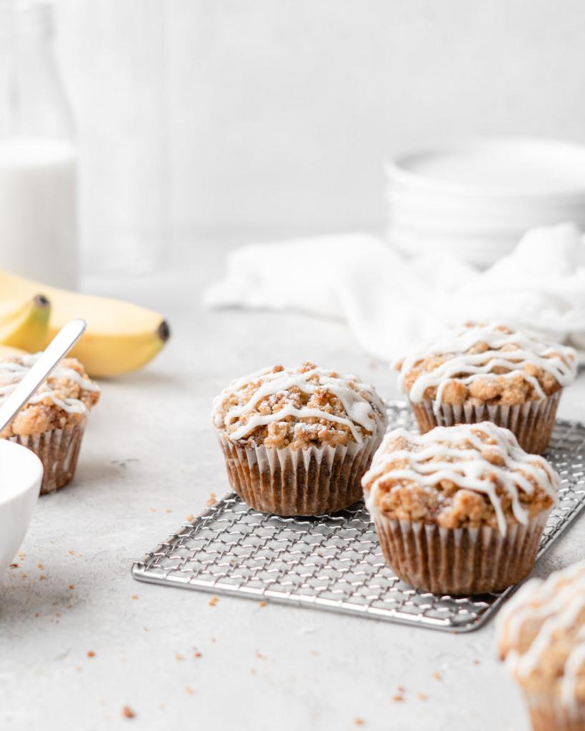 These moist banana muffins are topped with a buttery streusel topping and a simple creamy glaze!