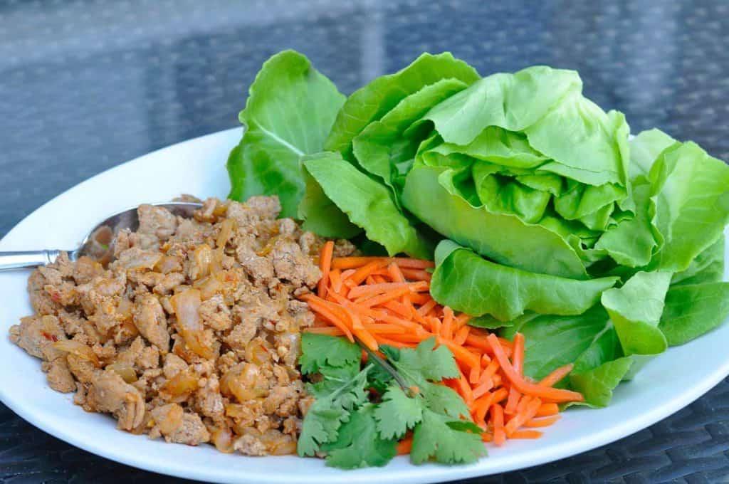 Lettuce wrap ingredients on white plate