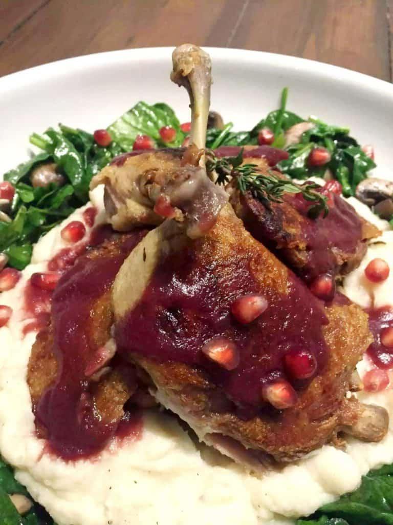 duck confit on white plate