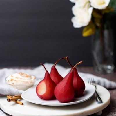 Image of pears in wine dessert on a white serving plate