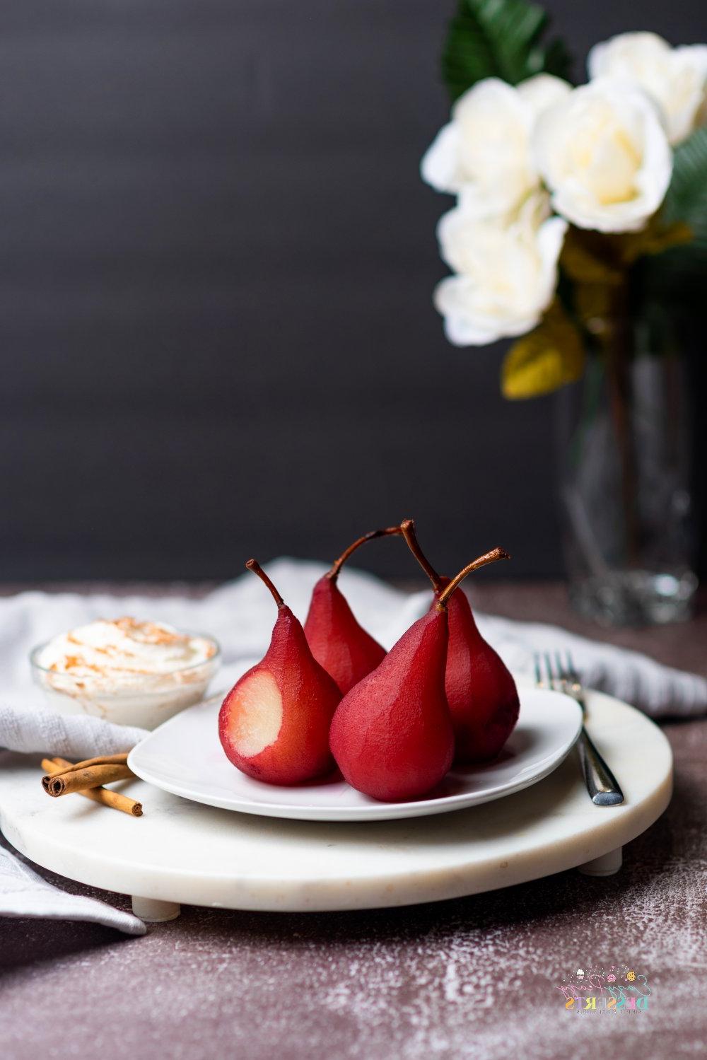 Image of pears in wine dessert on a white serving plate