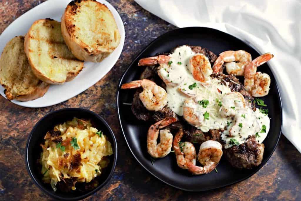 steak topped with shrimp and parmesan sauce