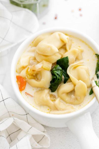 bowl with soup and spinach on top