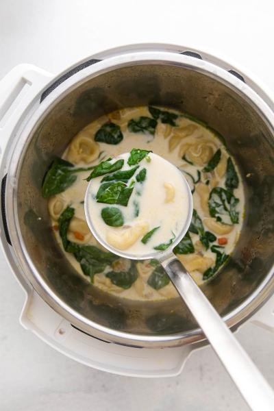 ladle picking up instant pot tortellini soup