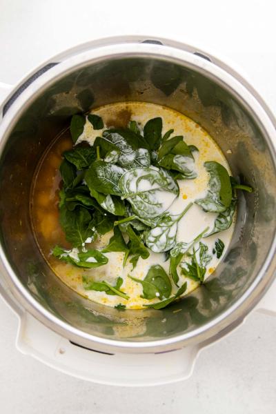 adding spinach and cream to instant pot bowl