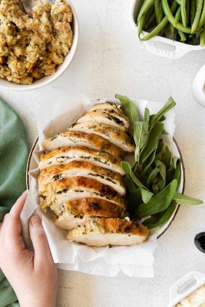 hand holding plate of turkey breast in instant pot